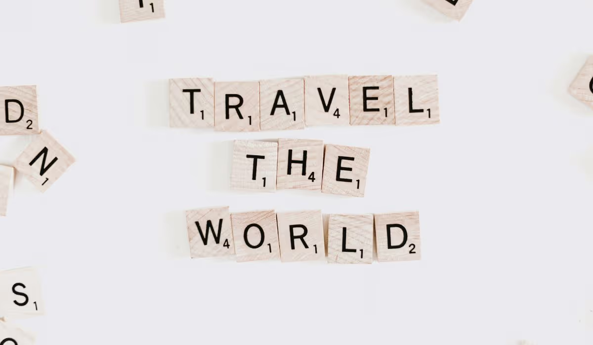Image of scrabble squares creating the words Travel the World – discuss a bespoke midlife adventure with The Leap