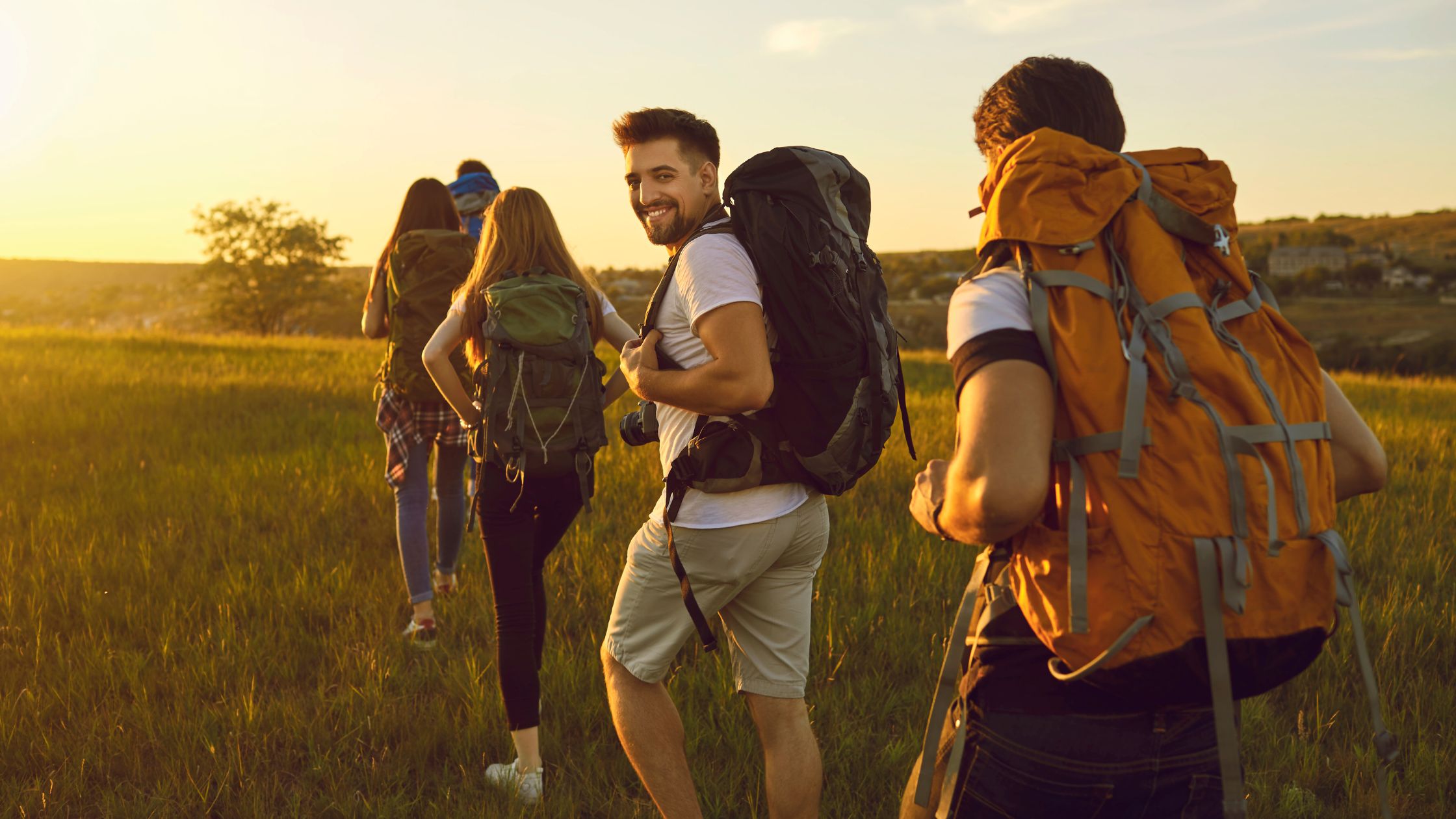 Backpacking gap year lads walking towards the sunset 
