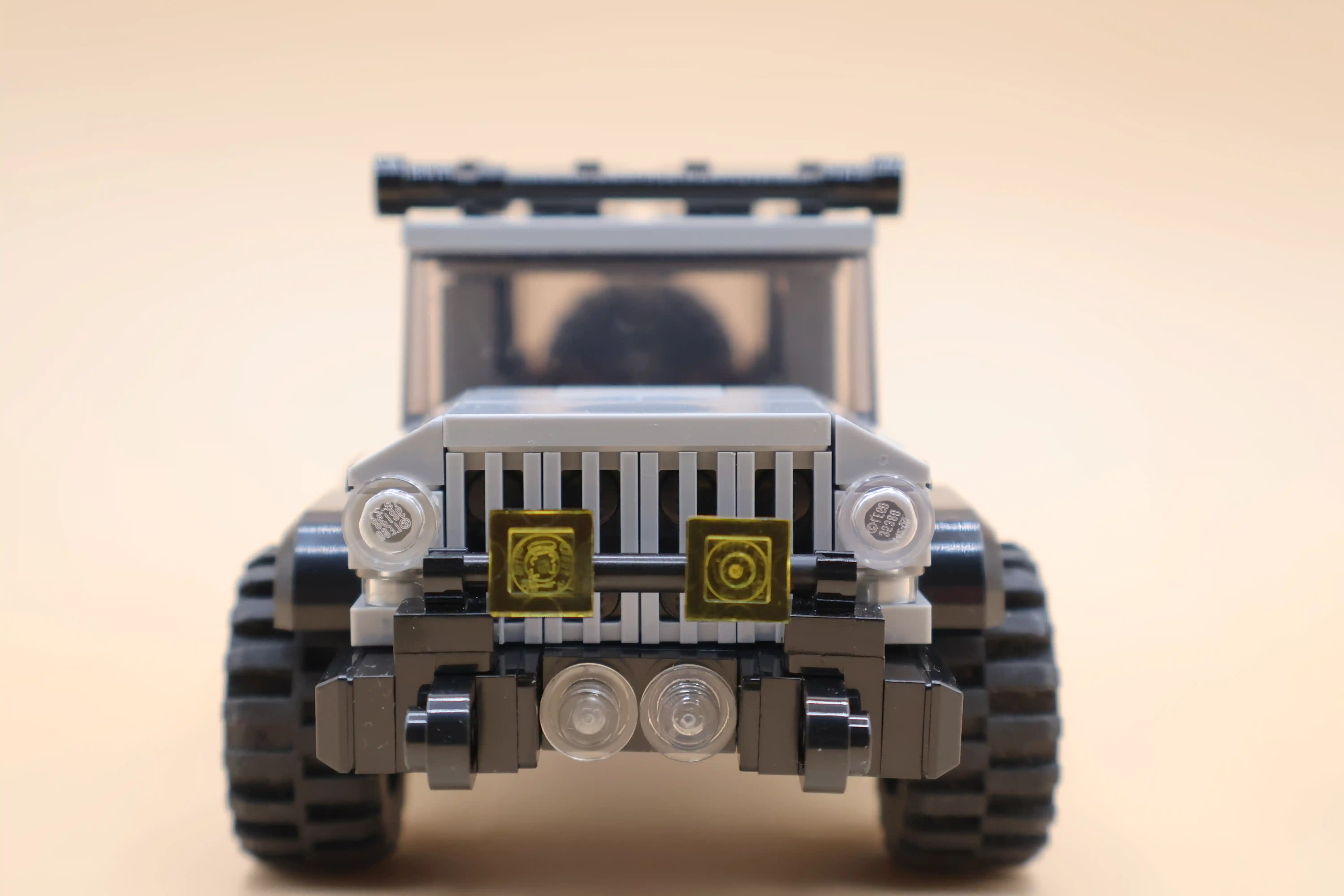 A custom LEGO commission by Ben Brickson of a gray 4-door Jeep Wrangler.