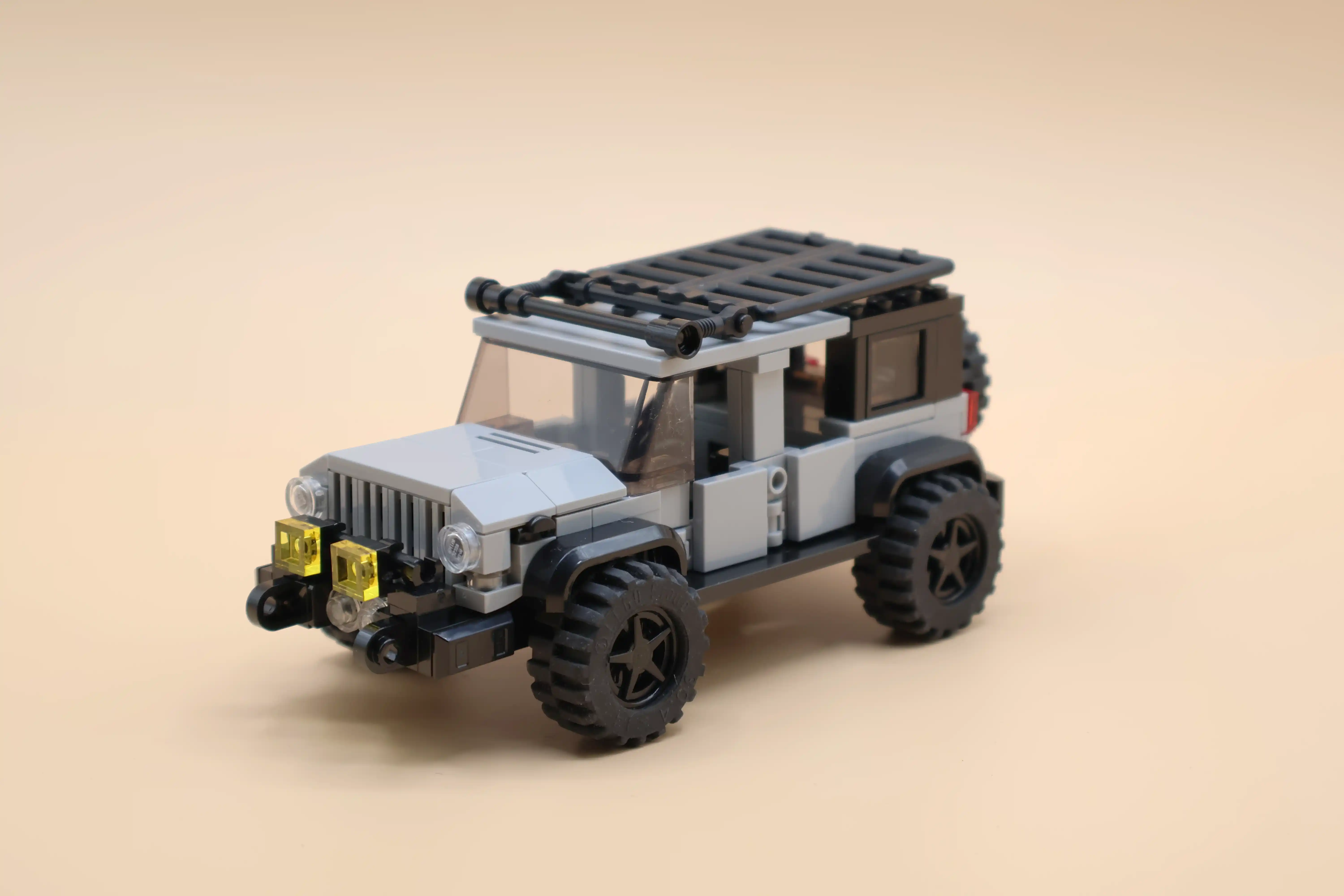 A custom LEGO commission by Ben Brickson of a gray 4-door Jeep Wrangler.