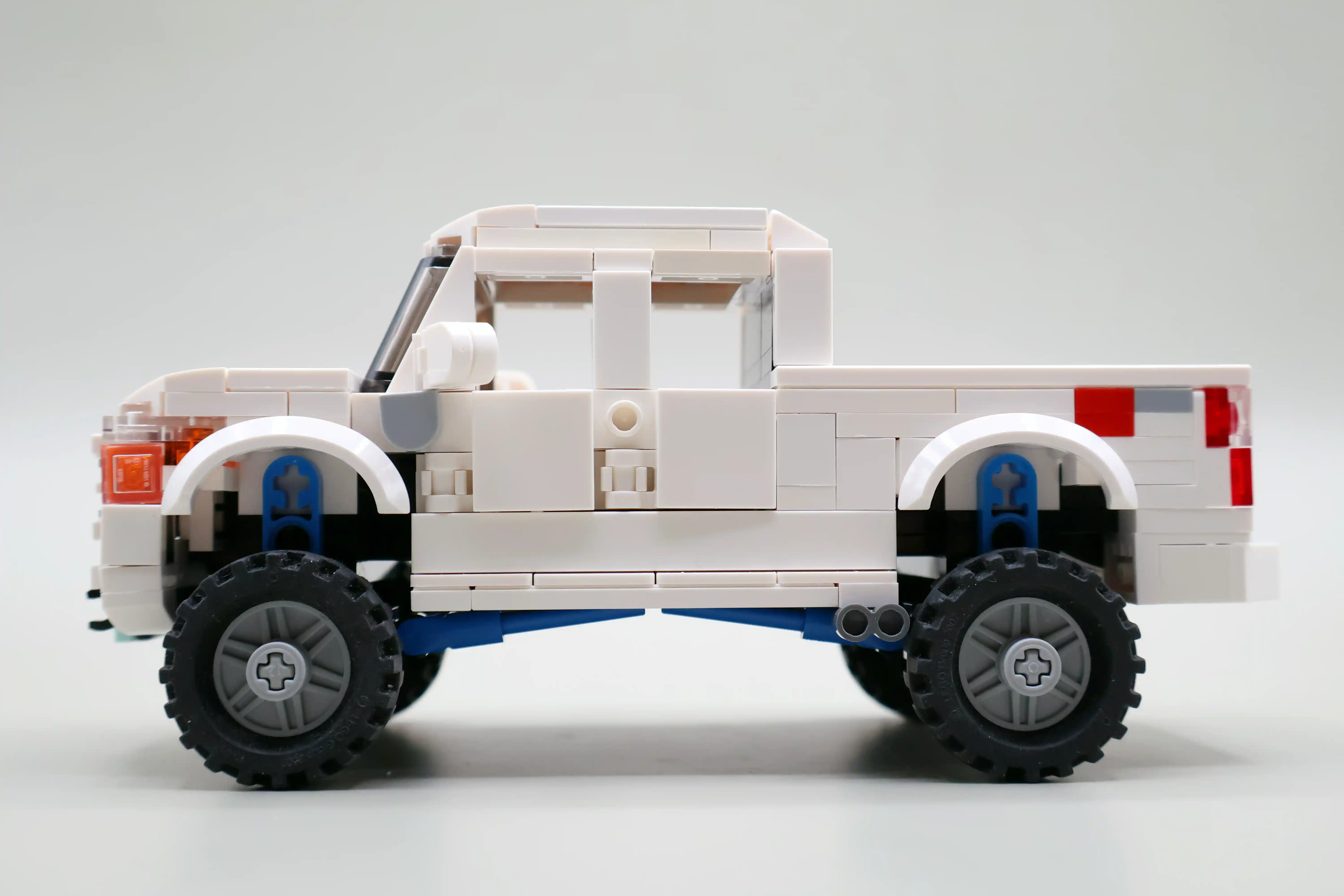 A custom LEGO commission by Ben Brickson of a white Ford F250 Truck with lift kit.
