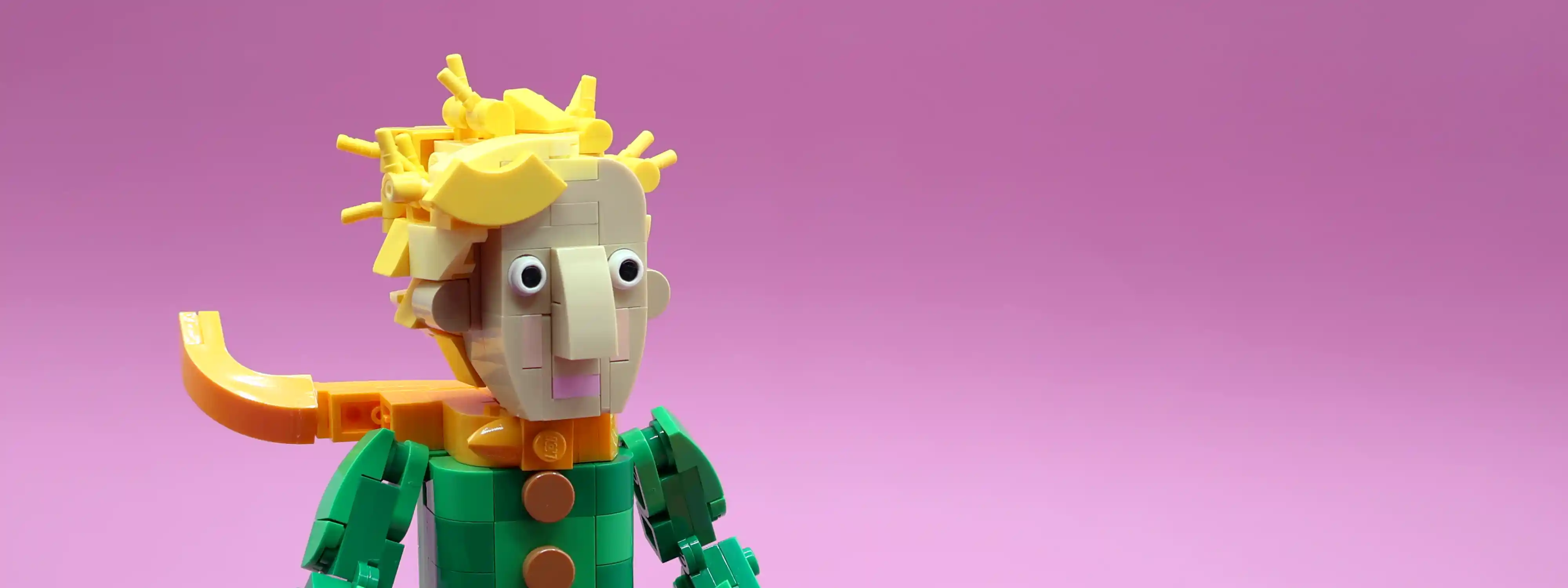 A custom LEGO commission by Ben Brickson of a the Little Prince, and his fox friend standing on the surface of a purple planet