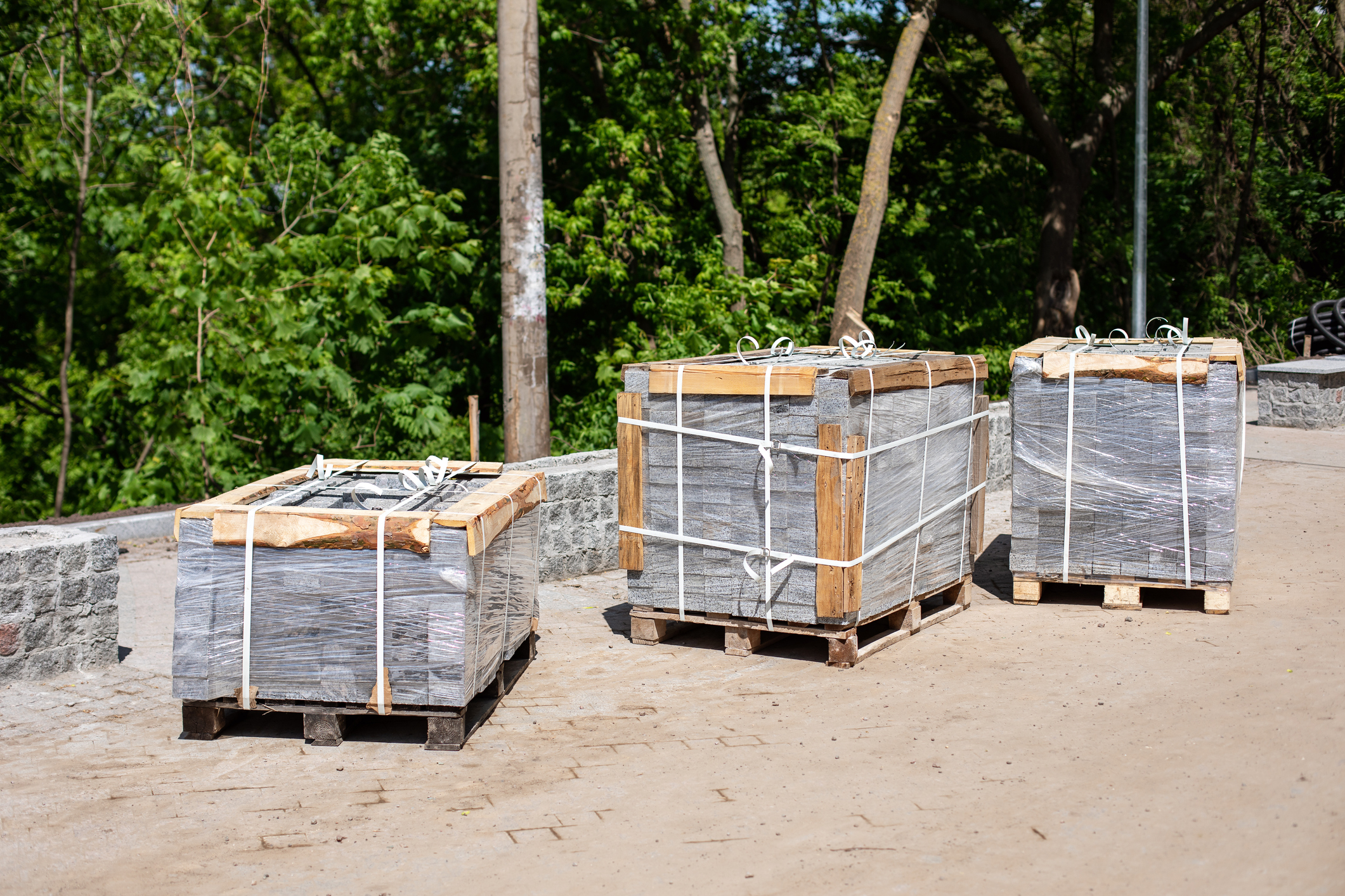 Several pallets with concrete new brick stacked on wooden pallets.