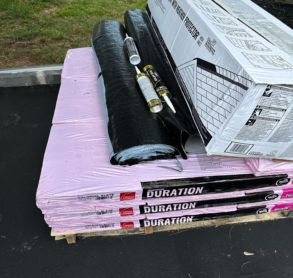 Owens Corning Duration shingles with roofing underlayment and sealant tubes on pallet