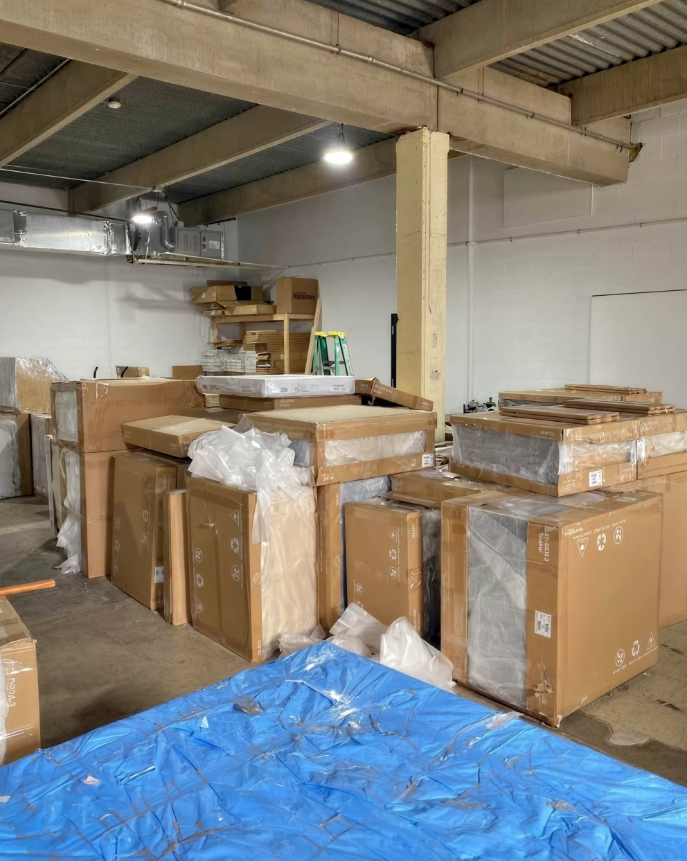 Warehouse filled with boxed bathroom vanities and cabinets ready for distribution.