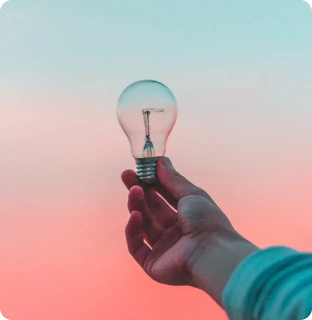 a person holding a light bulb in their hand