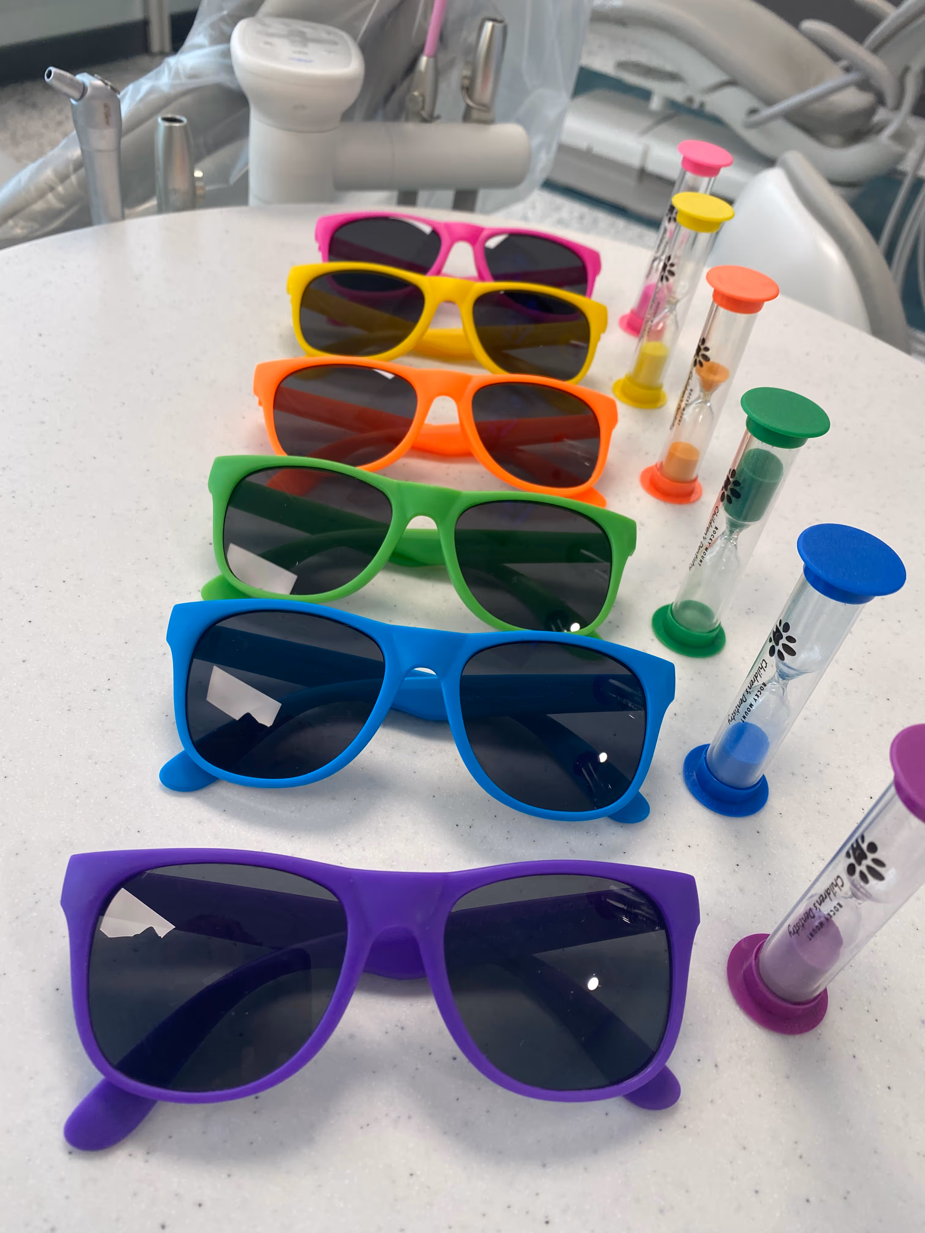 A group of sunglasses sitting on top of a table.