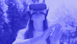 An image of a woman outside using a vr headset and reaching out. The entire image is made of shades of purple