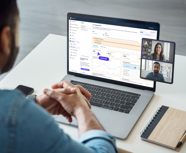 Person attending a video conference on a laptop displaying an assessment dashboard with charts and metrics.