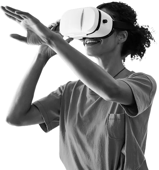 Smiling person wearing a virtual reality headset reaching forward with hands.