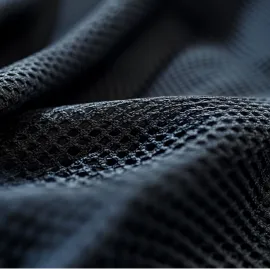 Close-up of black textured fabric with a honeycomb pattern.