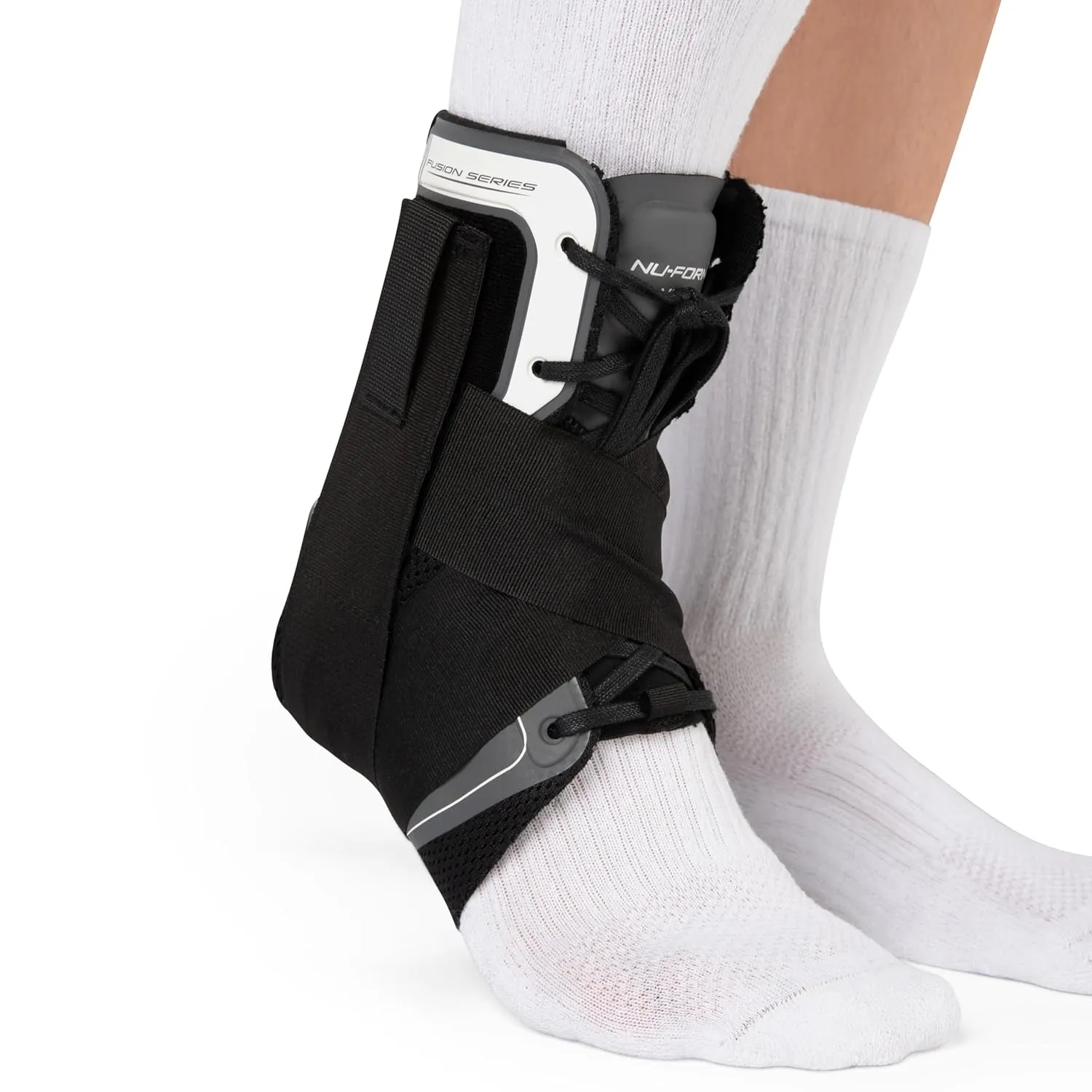 Person wearing a black ankle brace with white socks on both feet.