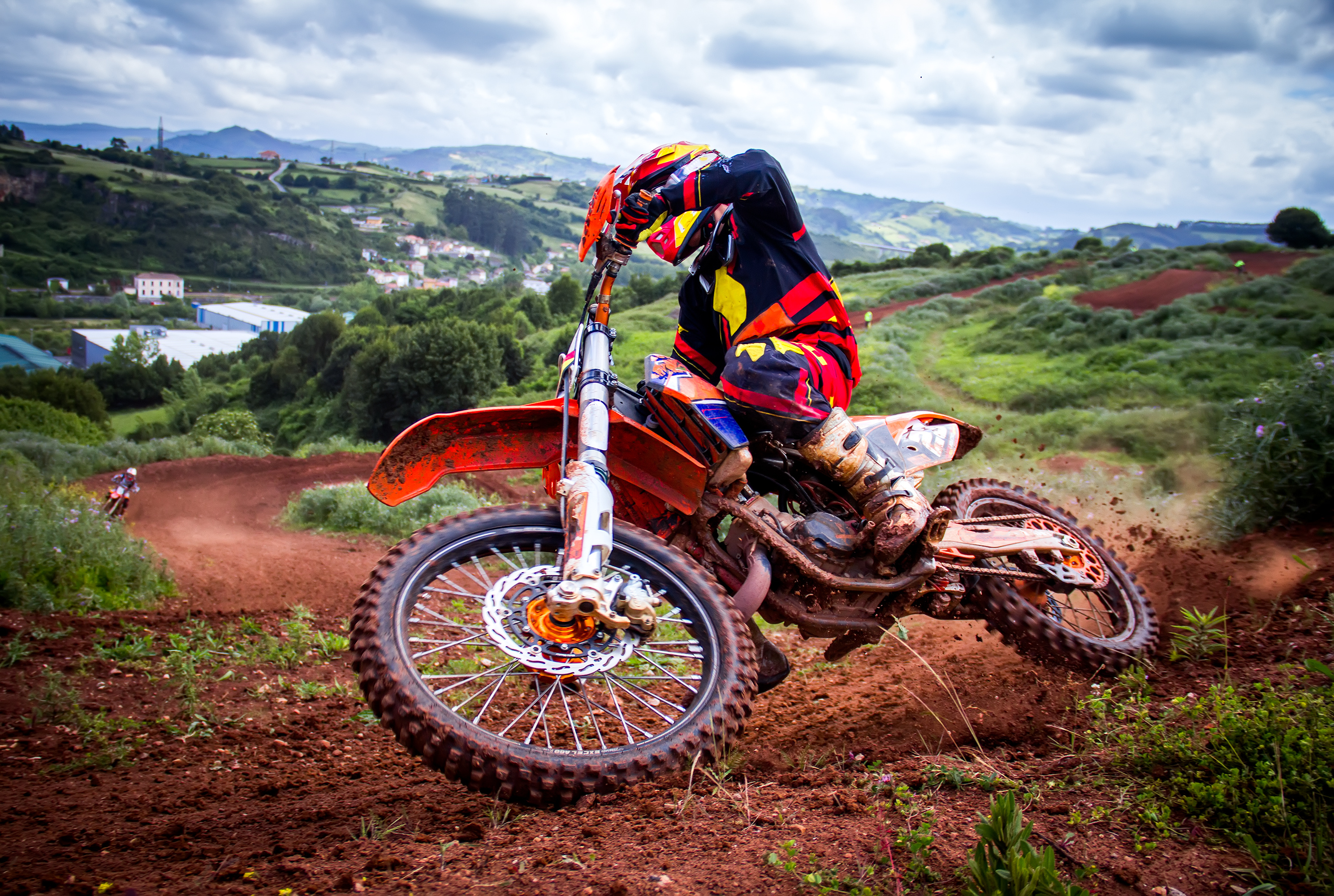A rider on a motocross bike going through a muddy corner