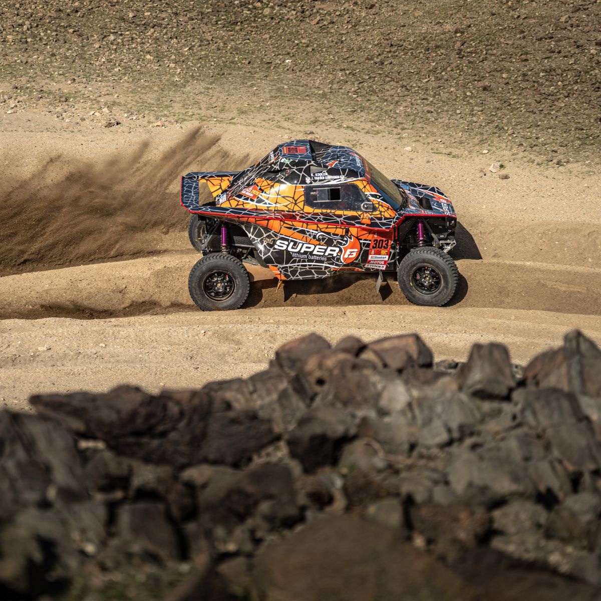 A rider on a motocross bike going through a muddy corner