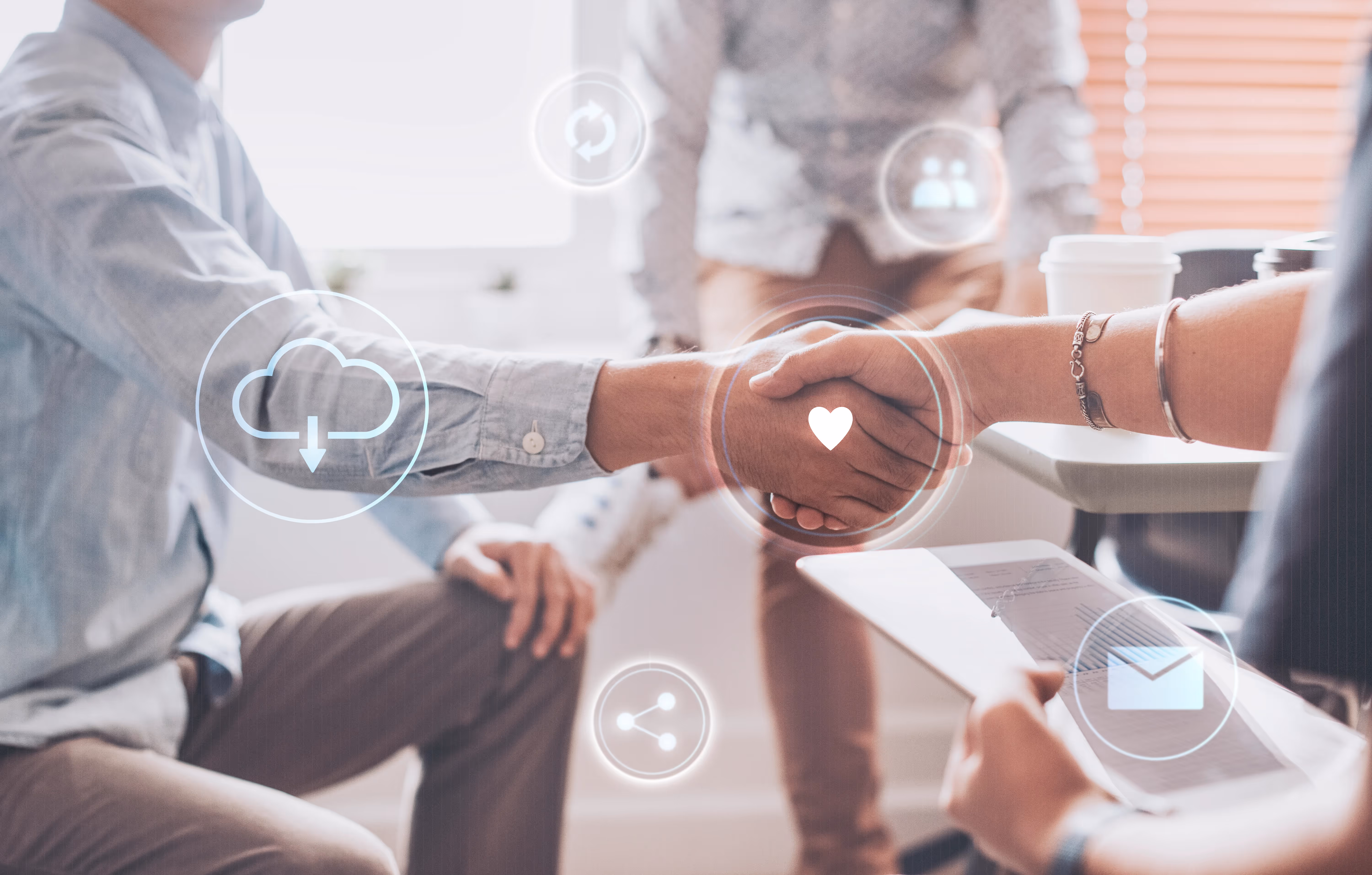 Two people shaking hands in a business meeting, with digital icons overlaid representing cloud, email, and sharing