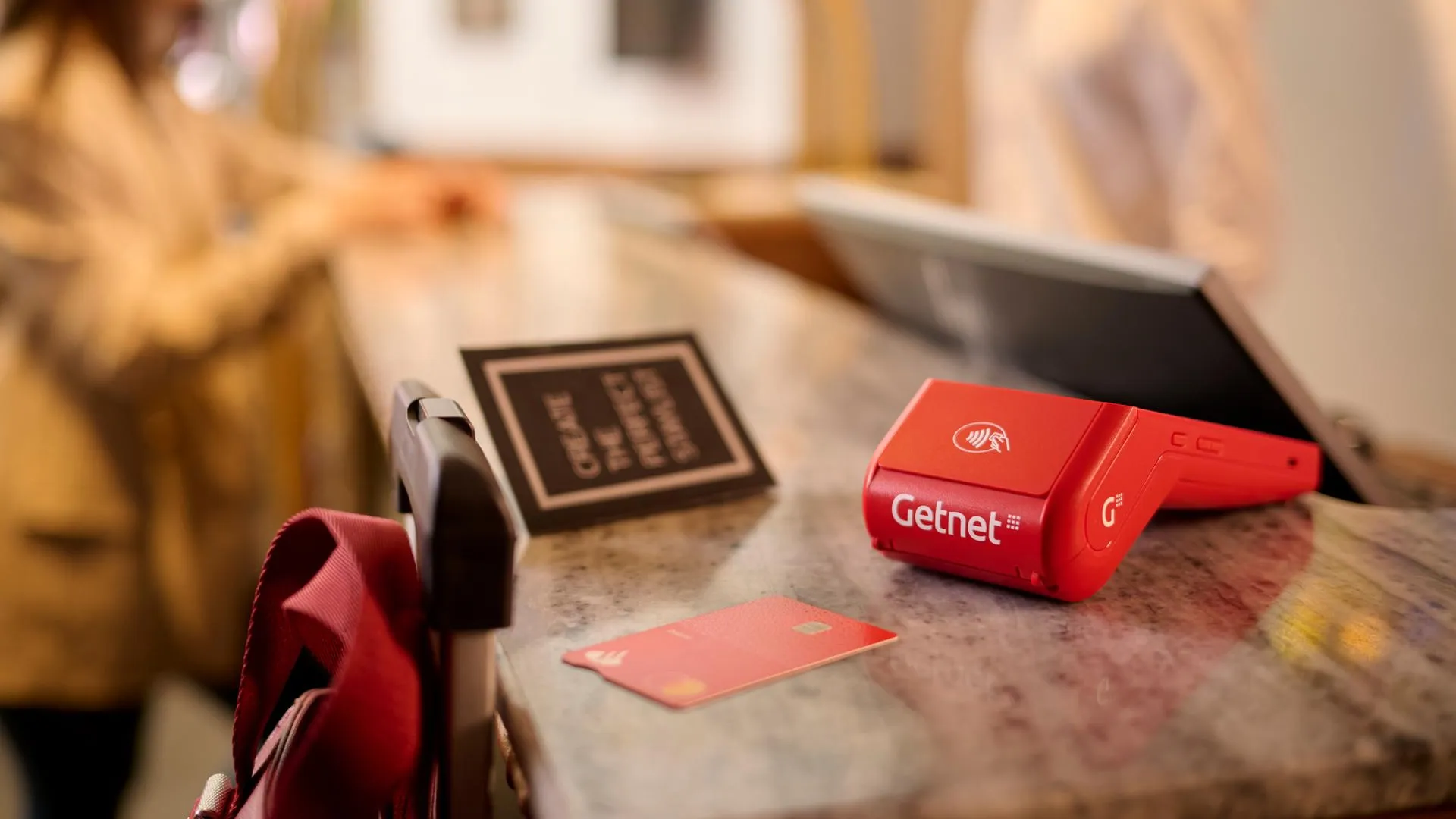 Datáfono GetSmart de Getnet en la recepción de un hotel esperando para cobrar con tarjeta de crédito. 