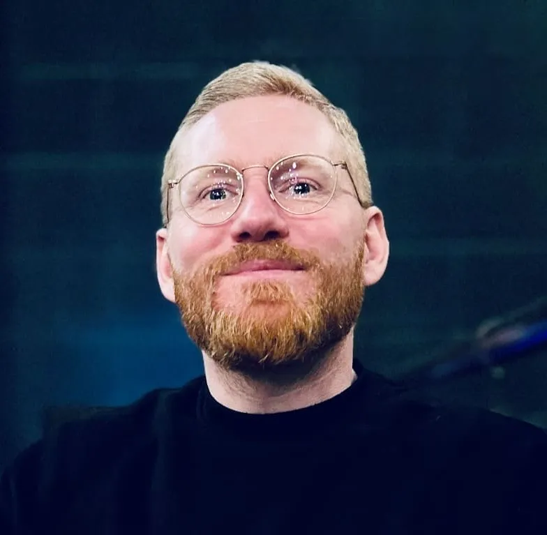 Man with short ginger hair and glasses - Will Kennard