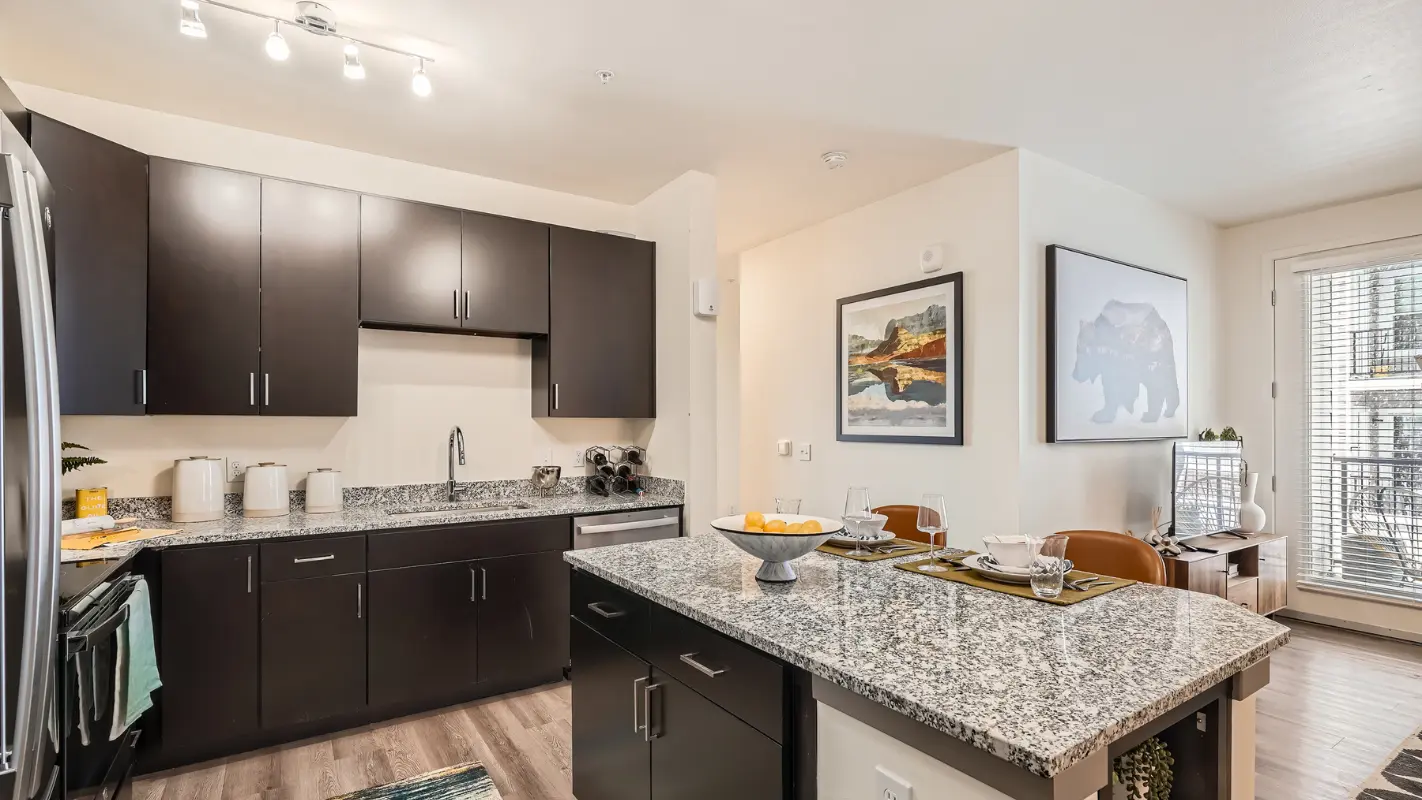 Kitchen with stainless steel appliances and granite countertops at Polaris Apartments in Broomfield, Colorado