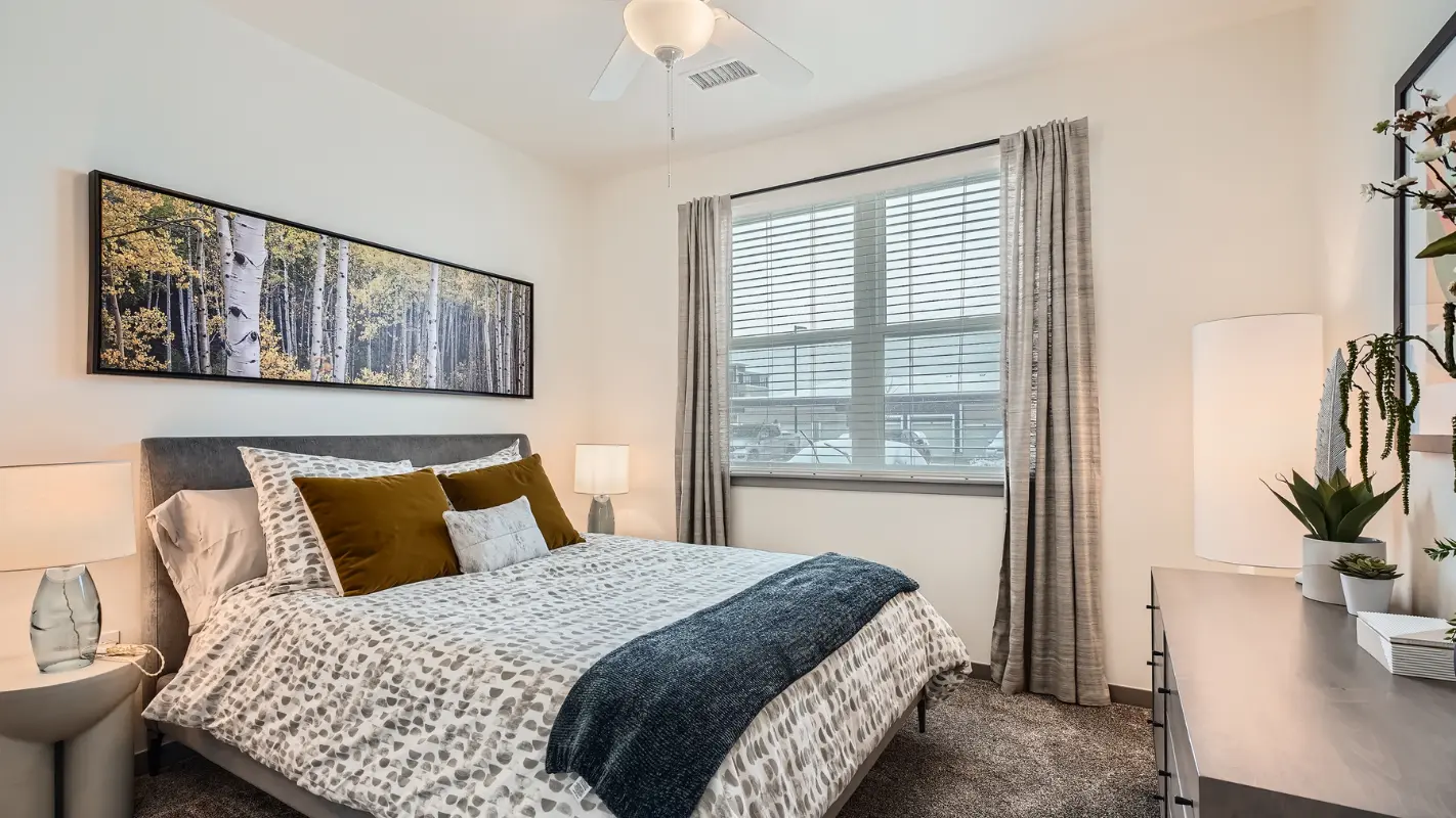 Bedroom with plush carpeting at Polaris Apartments in Broomfield, Colorado