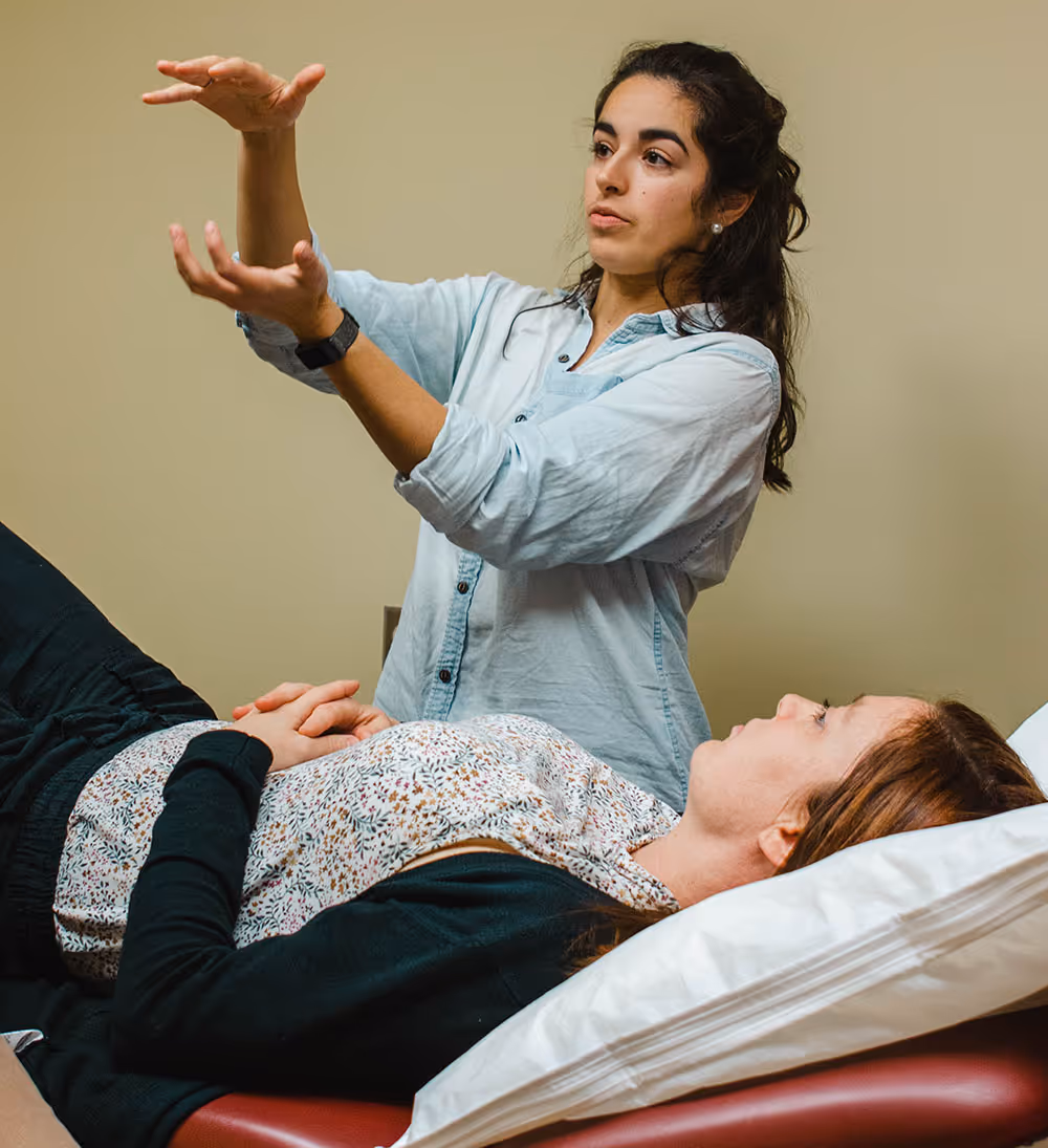 Une chiropracteur ajuste doucement le cou d'un patient sur une table de traitement médical chiropratique.