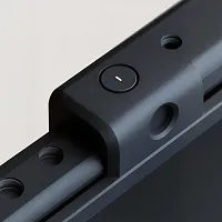 Close-up of a black modern device with a circular button featuring a minus symbol.