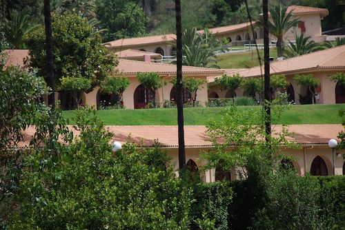a building with a lawn and trees