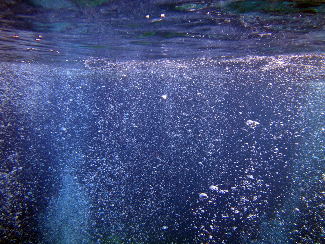 Bubbles rising in deep blue water