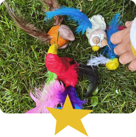photo of a small child's hand playing with plastiline figurines