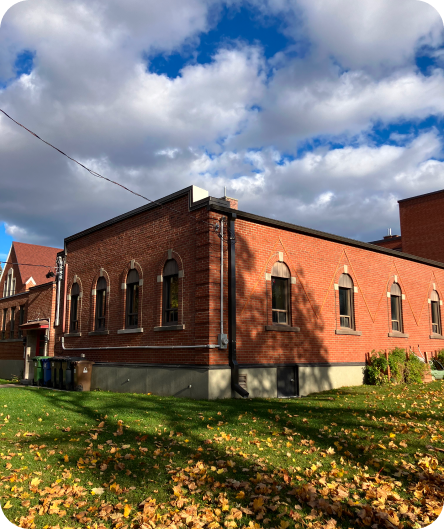 Outdoor photo if St Mark & St Peter Church. Red brick exterior with many arched windows