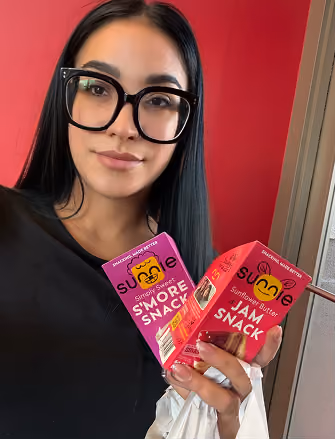 a woman holding a box of food