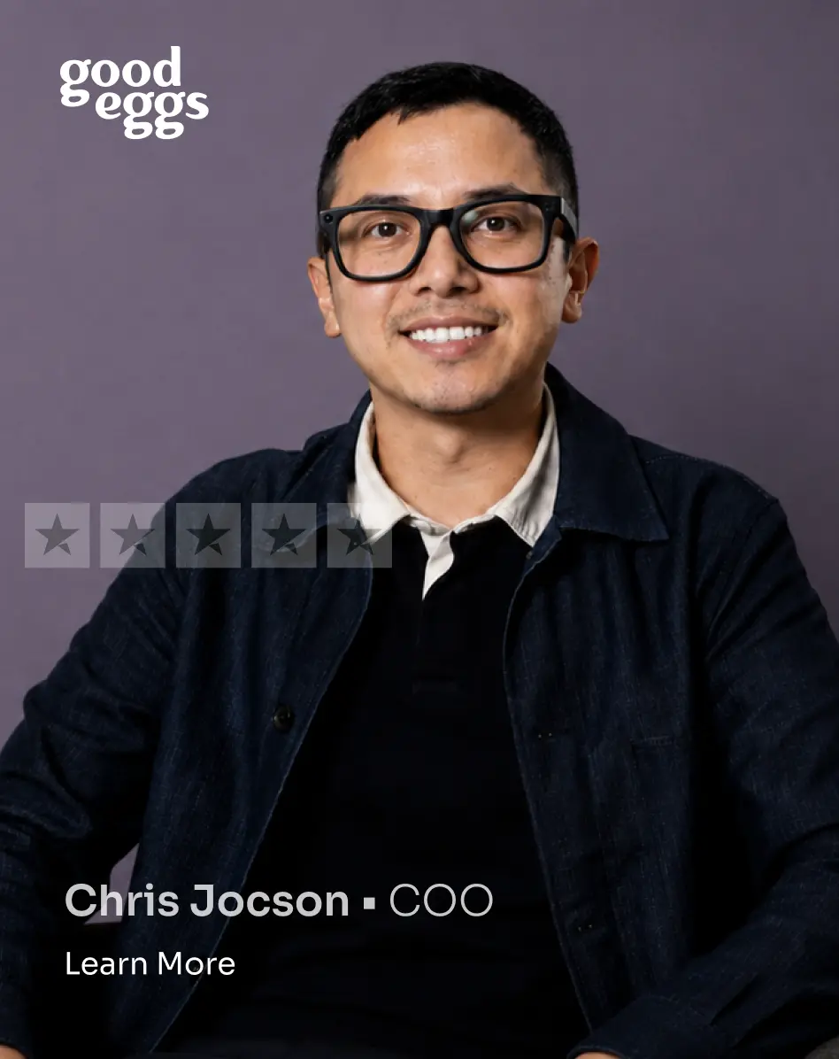 Portrait of Chris Jocson, COO, wearing glasses and a dark jacket over a collared shirt, smiling against a purple background with Good Eggs logo.