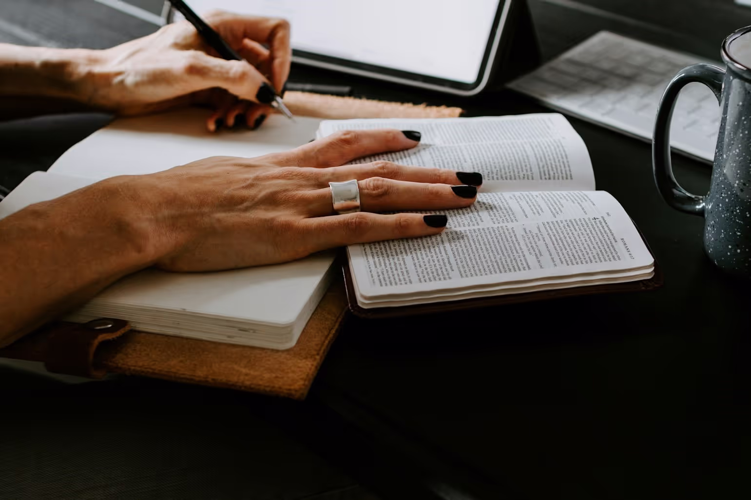 woman's hand with a notebook and a dictionary