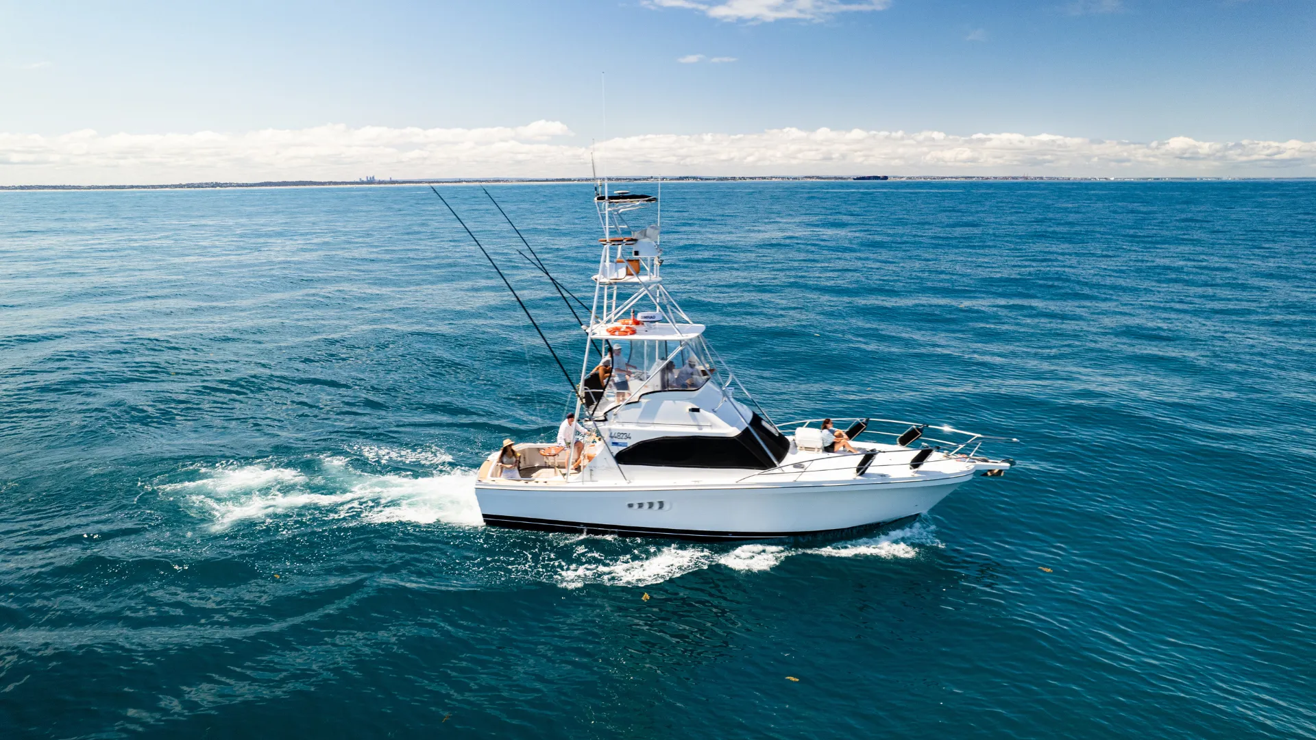 Game Time cruising on open blue water, seen from the side