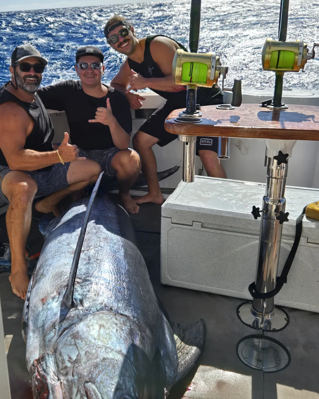 Group of anglers in the cockpit with a large tuna caught on a Game Time Charters charter