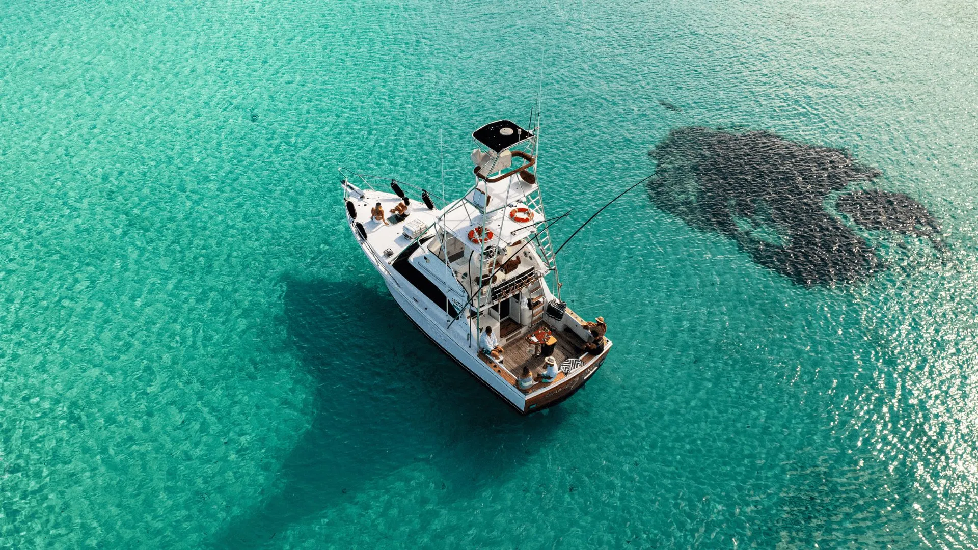 Game Time from above, anchored in clear turquoise water at Rottnest Island