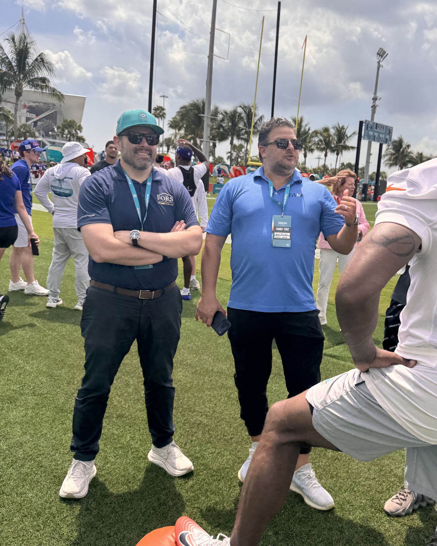 A FORS attorney in conversation on the practice field during training camp