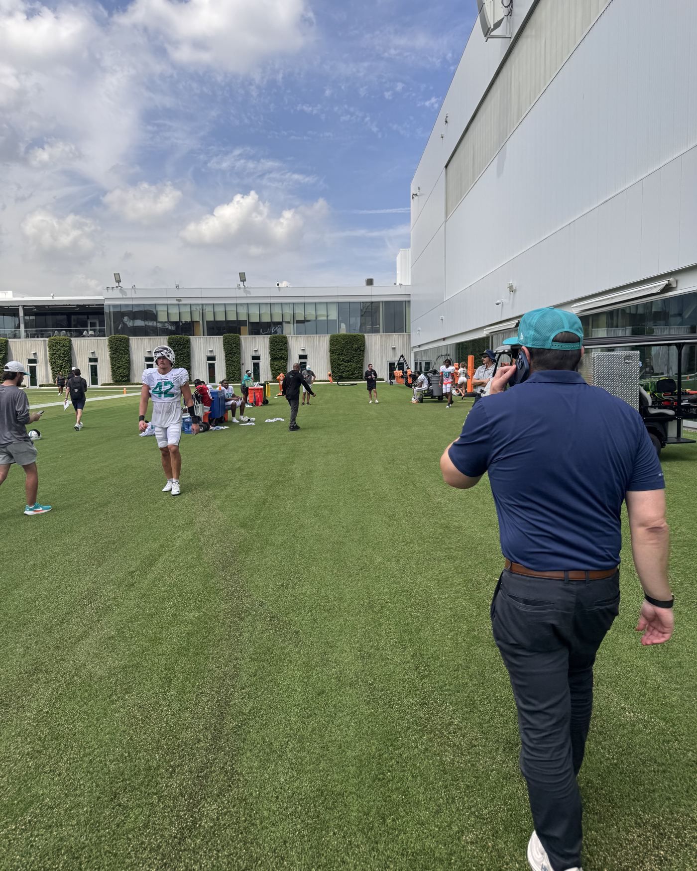 A FORS attorney walking onto the practice field at training camp