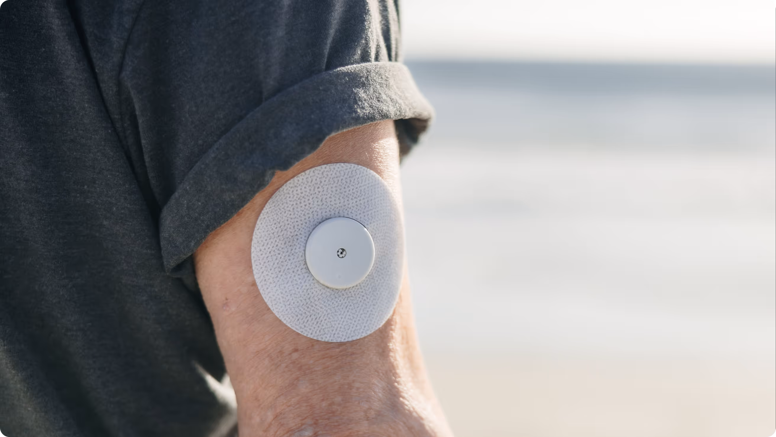 a person with a round patch on their arm