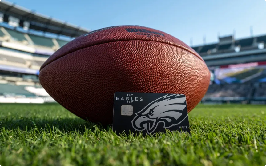 Eagles stadium with a football on field and debit card.