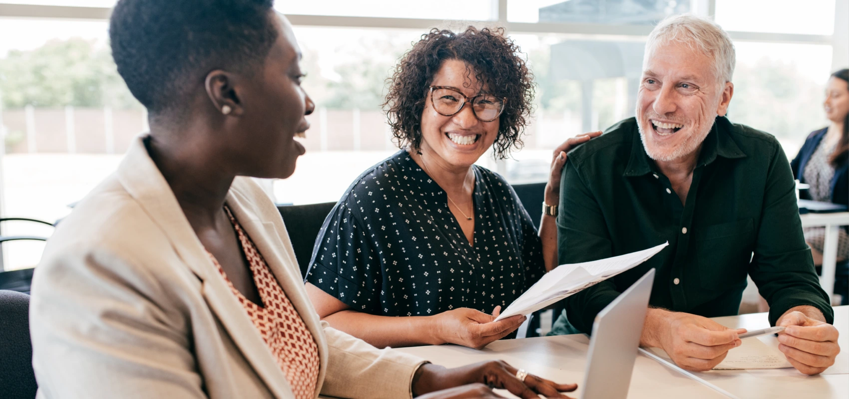 Man and woman meeting at a branch reviewing paperwork and a computer