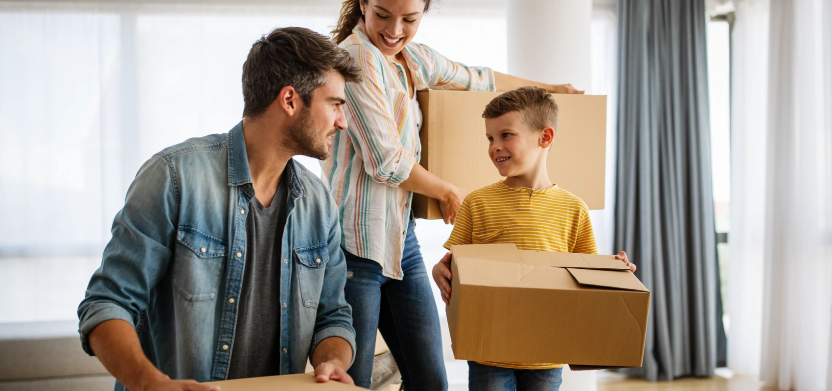 Mom, Dad, and son packing moving boxes