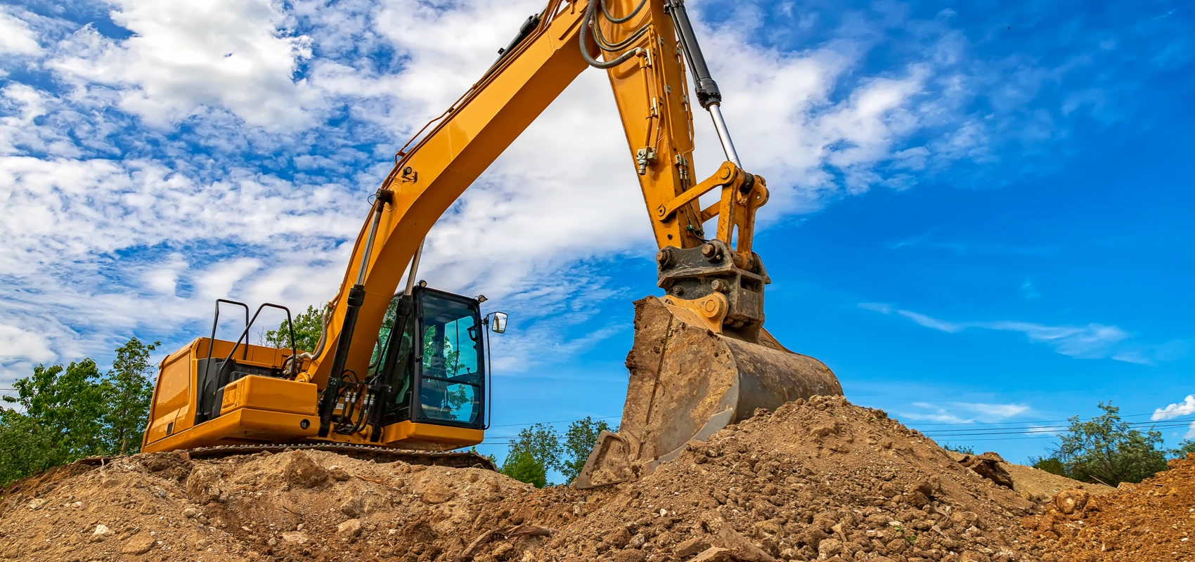 Backhoe digging at a construction site.