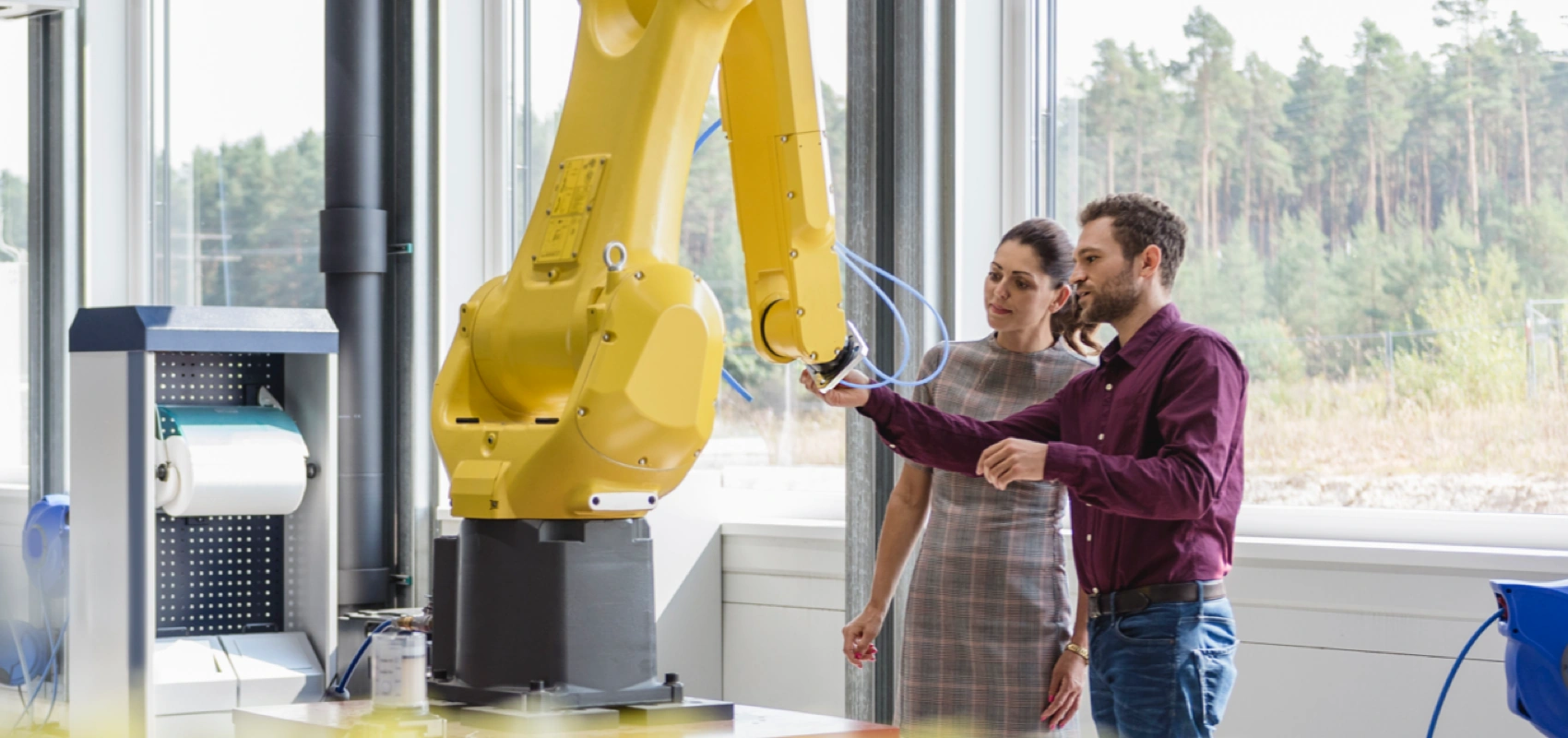 Two people inspecting manufacturing equipment