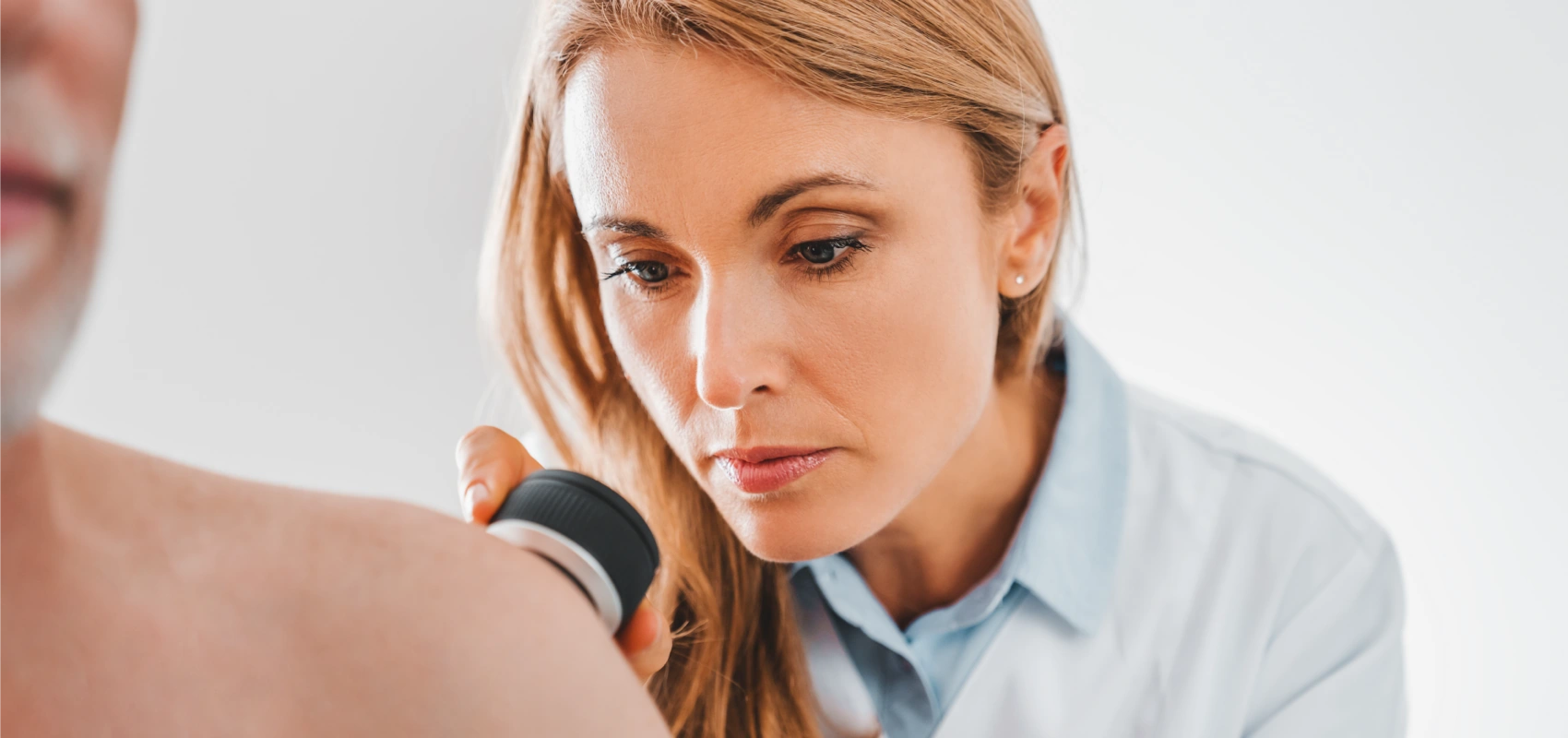 Dermatologist evaluating skin