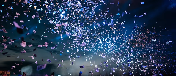 Banknotes falling through the air against a dark, cloudy sky background.