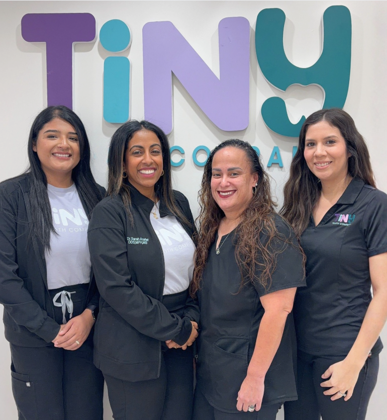 Friendly Tiny Dental Company team of pediatric dentists, hygienists, and support staff gathered together, welcoming families to their pediatric dental practice in The Woodlands, TX