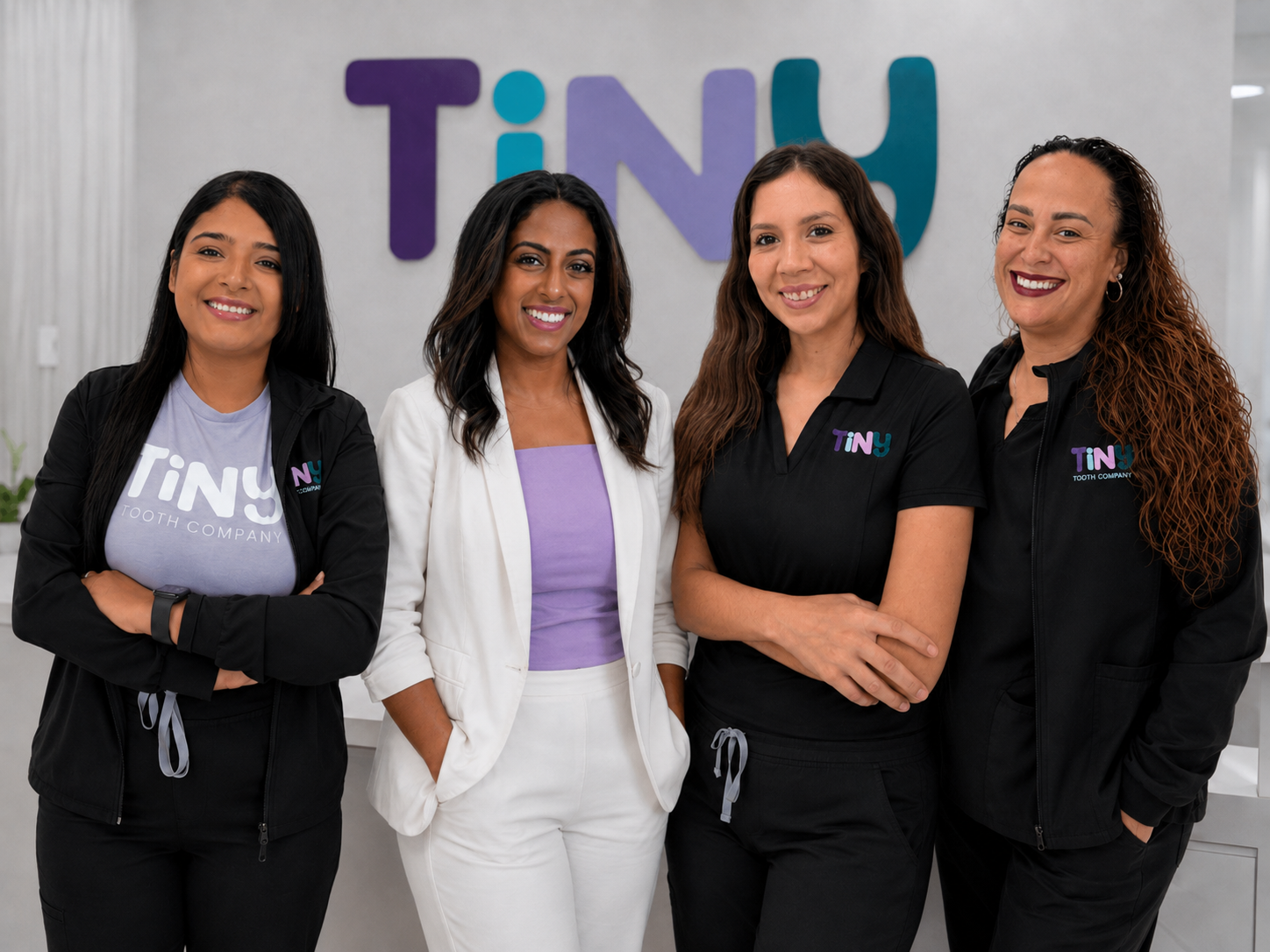 Friendly Tiny Dental Company team of pediatric dentists, hygienists, and support staff gathered together, welcoming families to their pediatric dental practice in The Woodlands, TX
