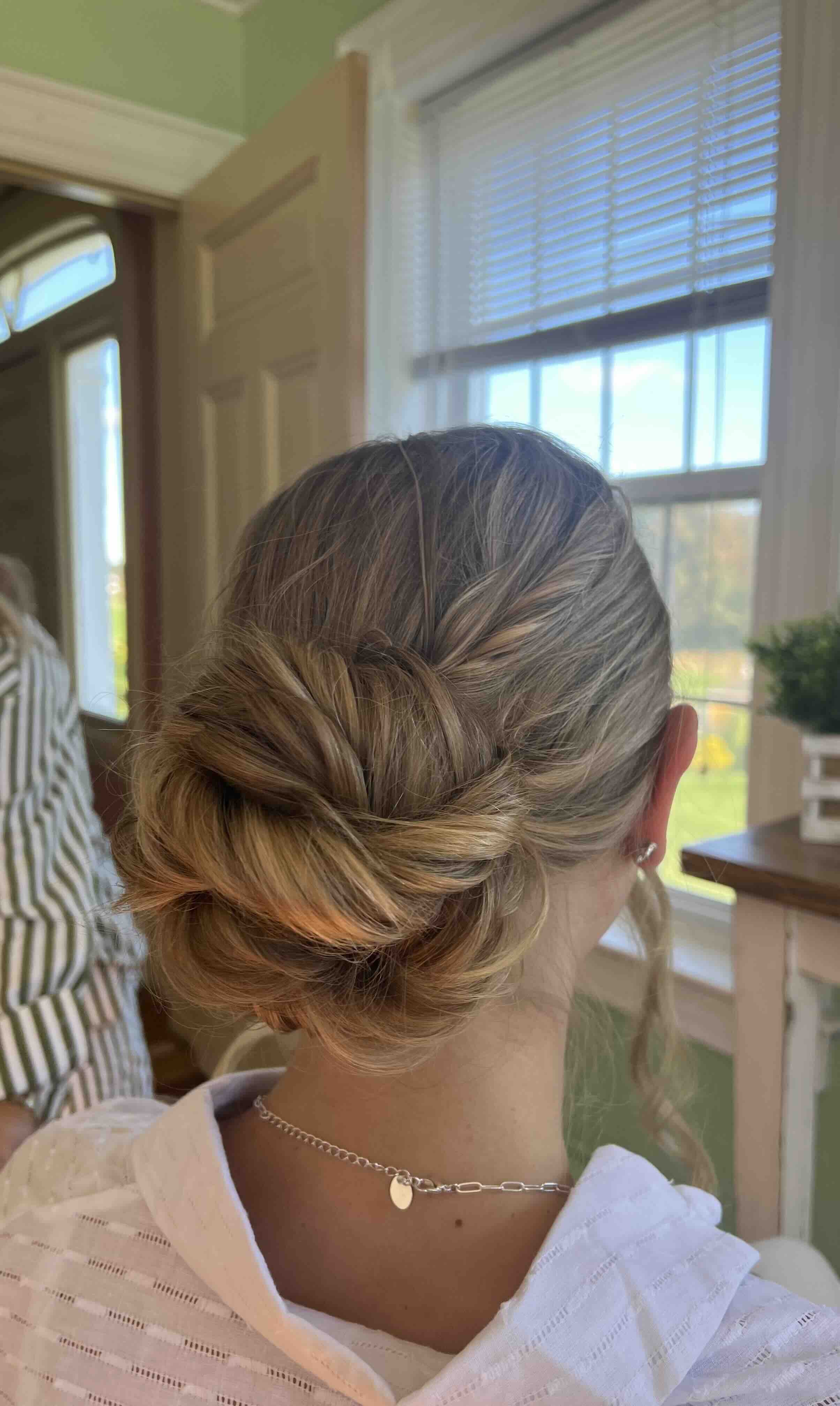Bride with blonde hair in an elegant updo.