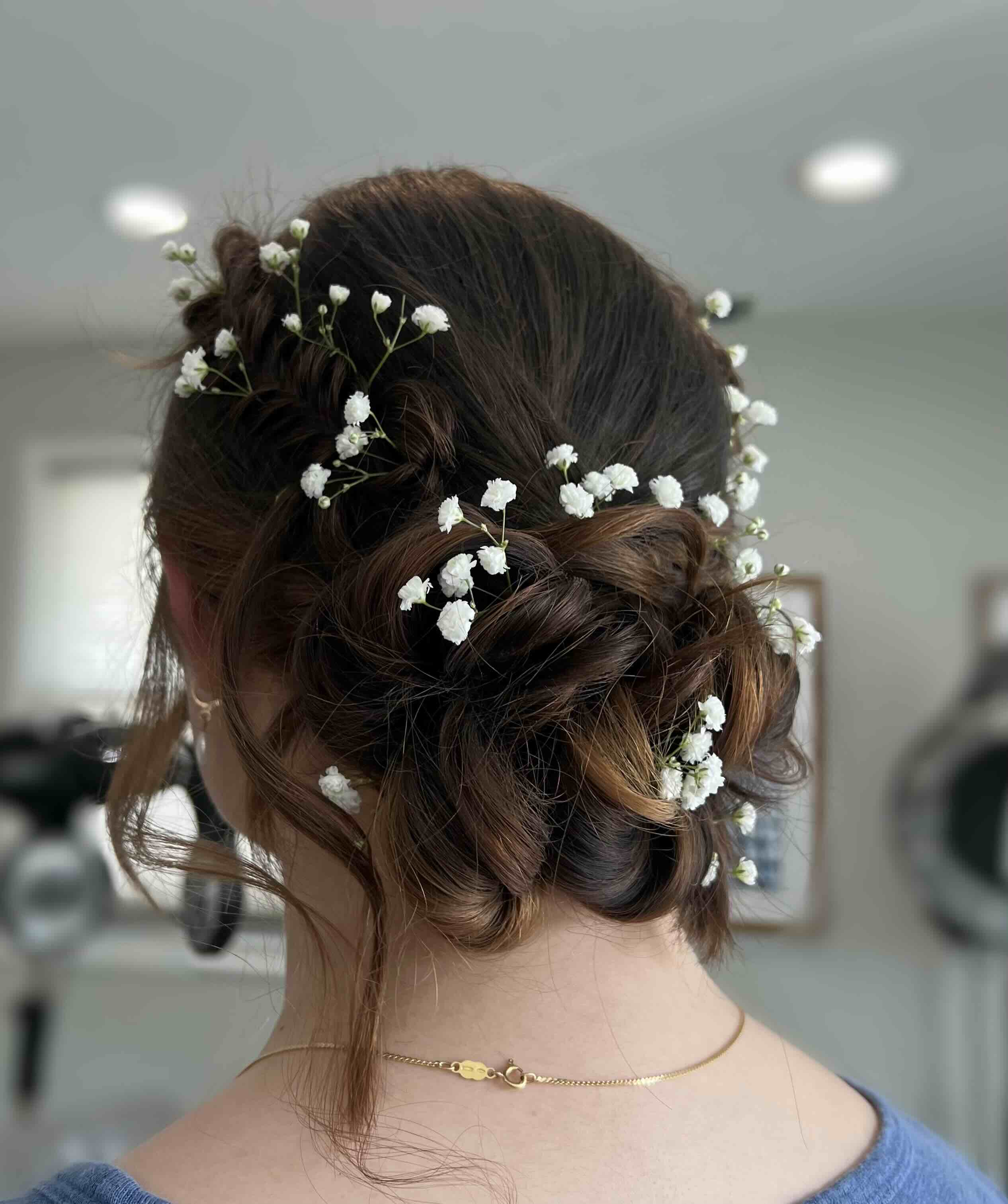 Bride with brunette hair in elegant updo with hair piece woven in.