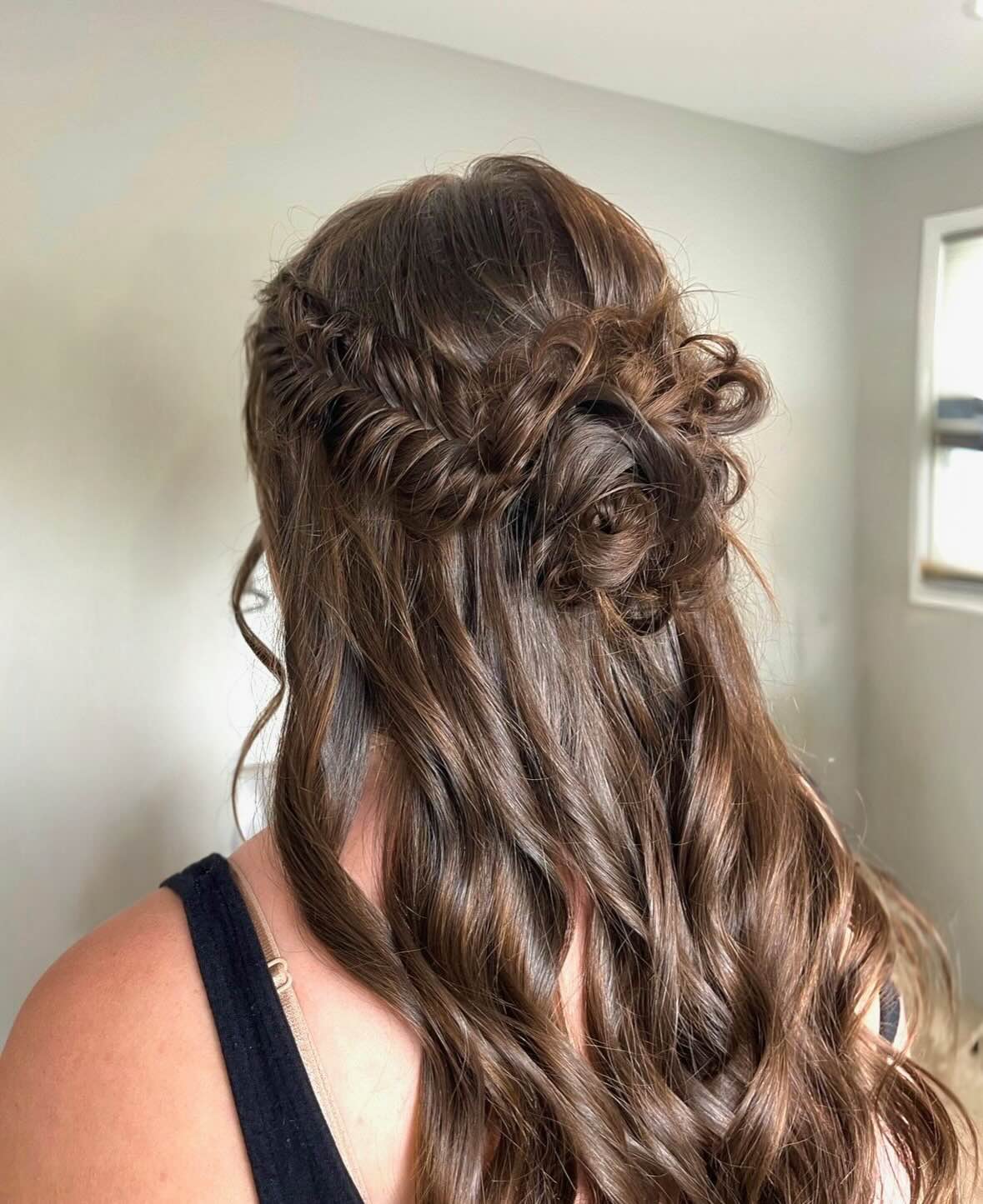 Bride with brunette hair in elegant half up half down hair style.